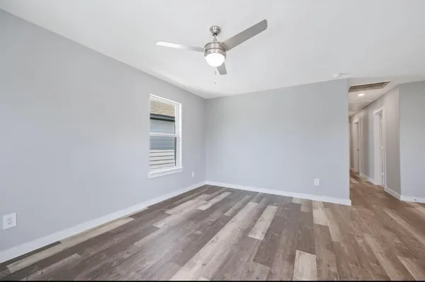 wooden floor in an empty room with a window