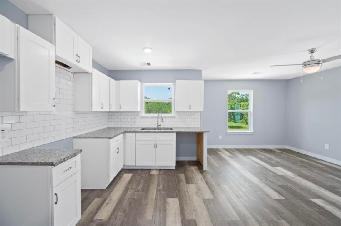622 Maple Way Houston, TX 77015 - Photo 7 of 23 a kitchen with granite countertop a stove sink and cabinets