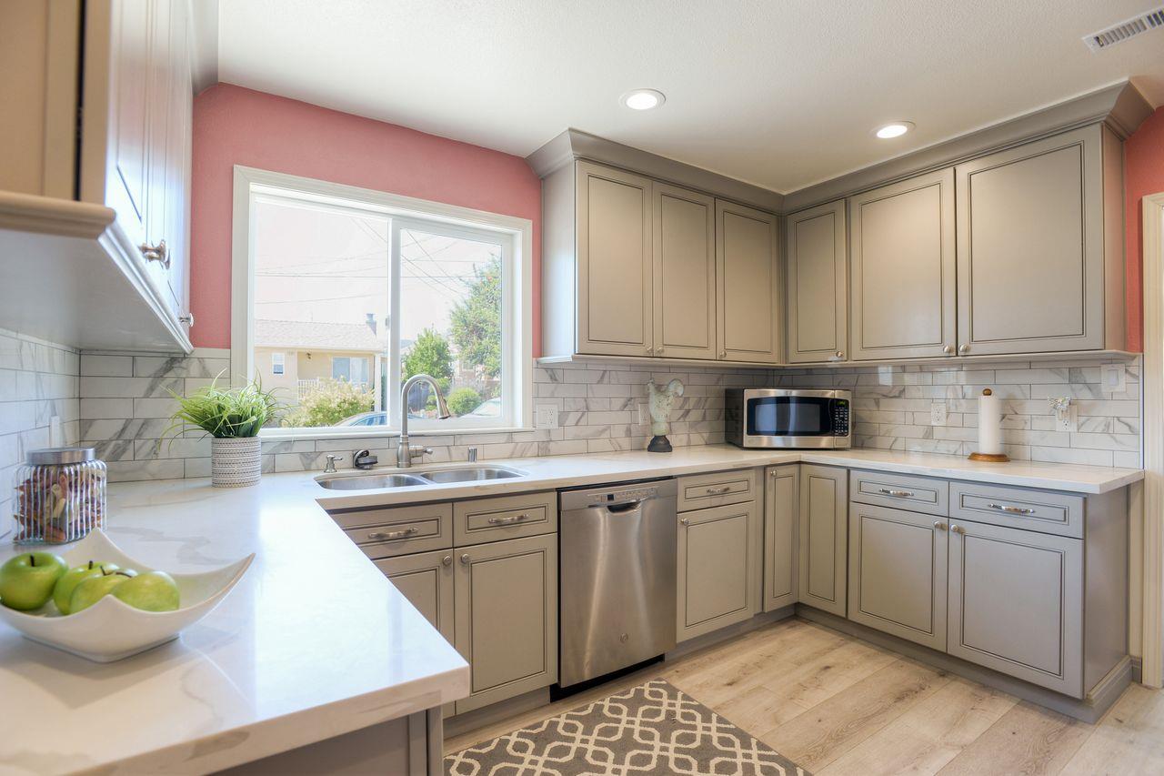 15 Robert Place Millbrae, CA 94030 - Photo 14 of 30 a kitchen with a sink stove and white cabinets
