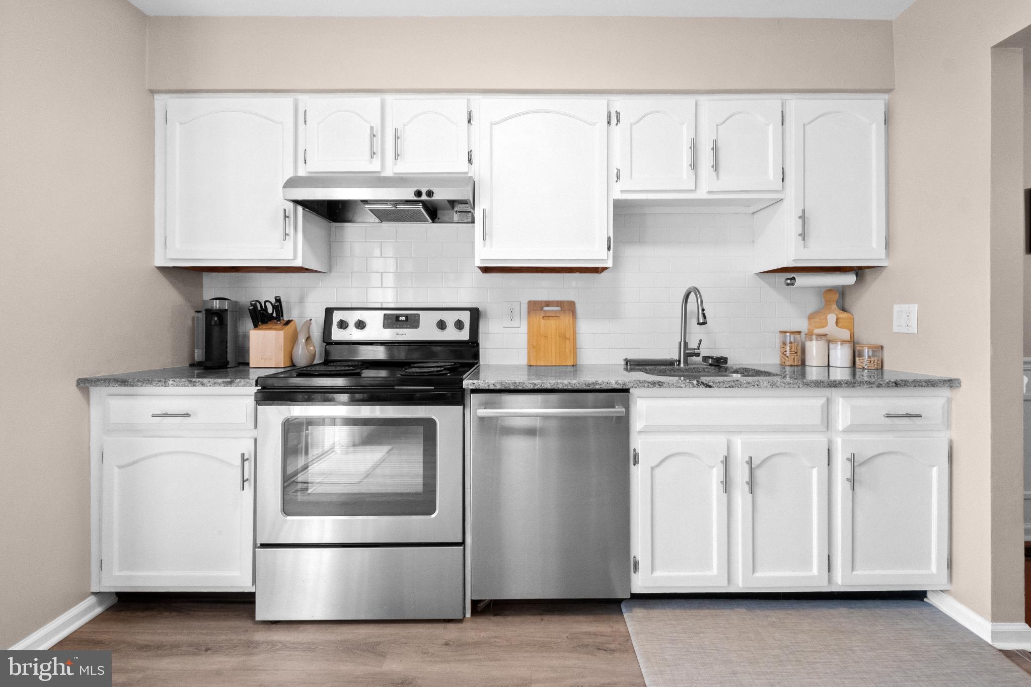 210 Martins Way Mount Laurel, NJ 08054 - Photo 7 of 38 a kitchen with stainless steel appliances granite countertop a sink stove and white cabinets