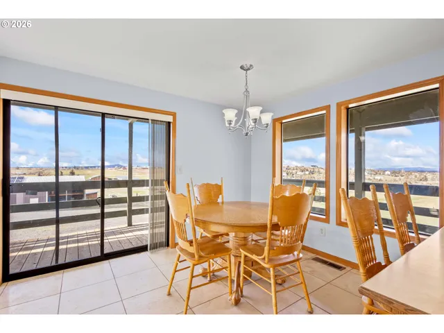 a dining room with furniture and floor to ceiling windows