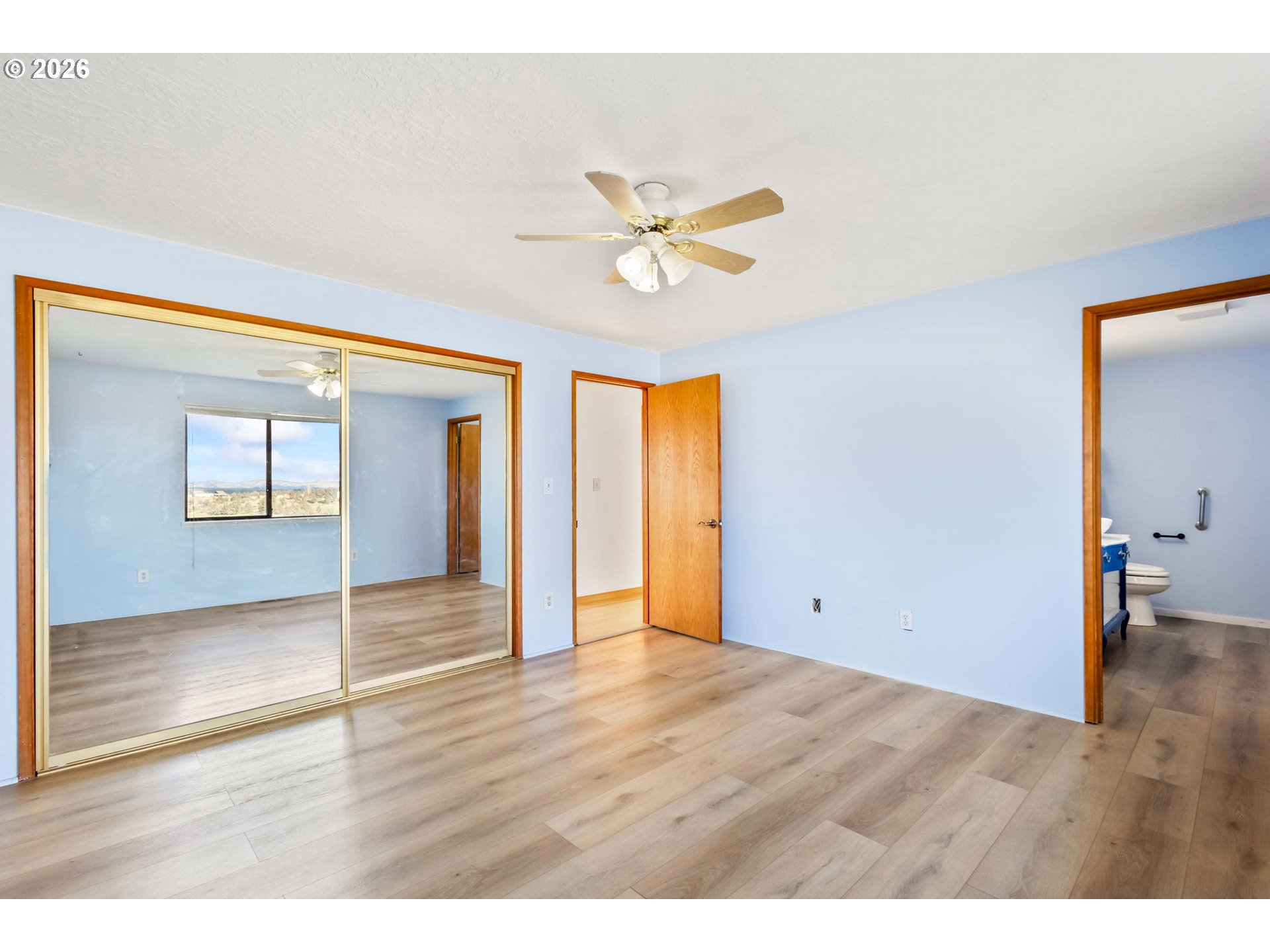 896 Southeast Dover Lane Madras, OR 97741 - Photo 15 of 44 a view of an empty room with window and wooden floor