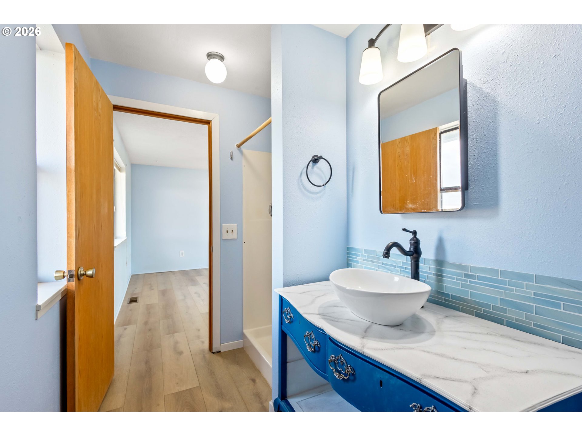 896 Southeast Dover Lane Madras, OR 97741 - Photo 16 of 44 a bathroom with a sink mirror and vanity