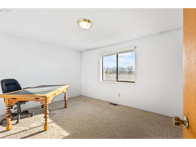 a view of a room with gym equipment and a window