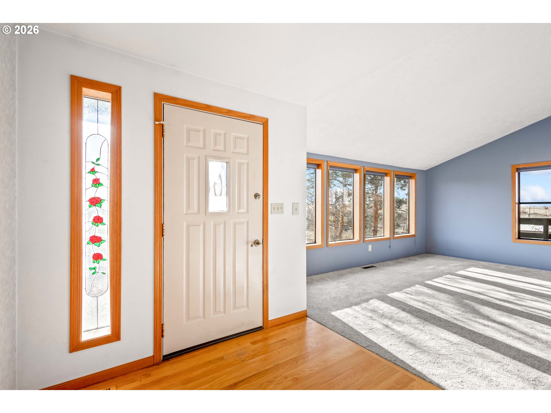 896 Southeast Dover Lane Madras, OR 97741 - Photo 7 of 44 a view of an empty room with wooden floor and a window