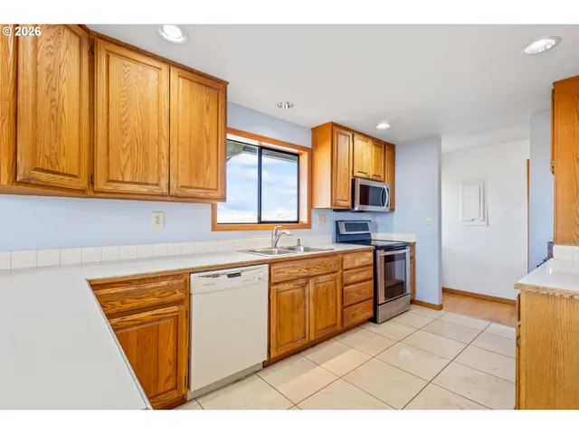 a kitchen with stainless steel appliances granite countertop a sink and cabinets