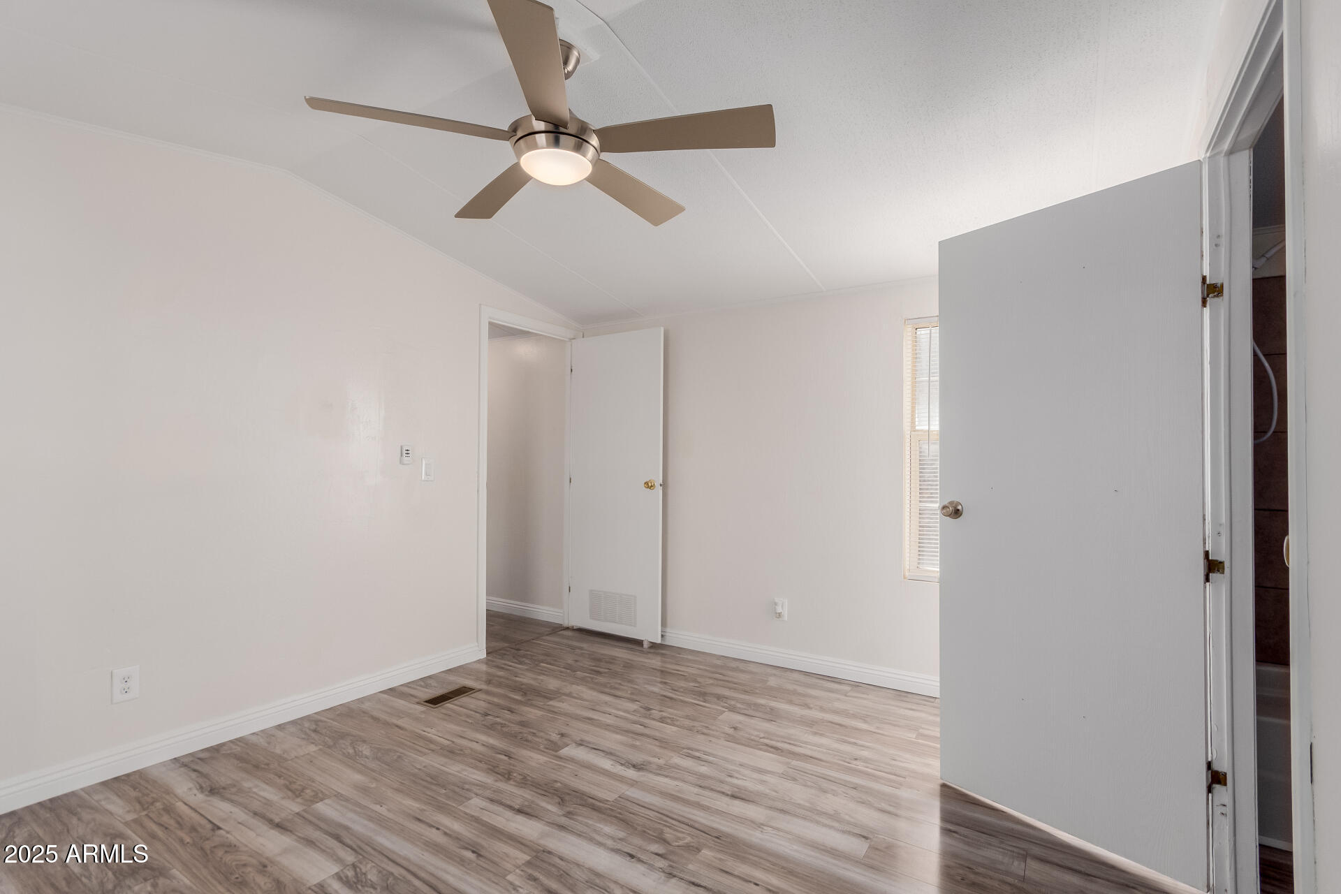 2000 South Apache Road, Unit 276 Buckeye, AZ 85326 - Photo 12 of 27 a view of an empty room with wooden floor