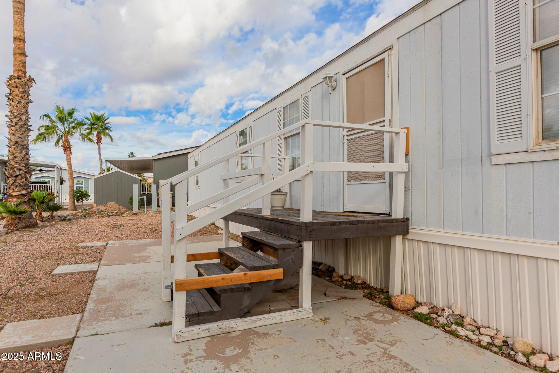 2000 South Apache Road, Unit 276 Buckeye, AZ 85326 - Photo 24 of 27 a backyard of a house with barbeque oven table and chairs