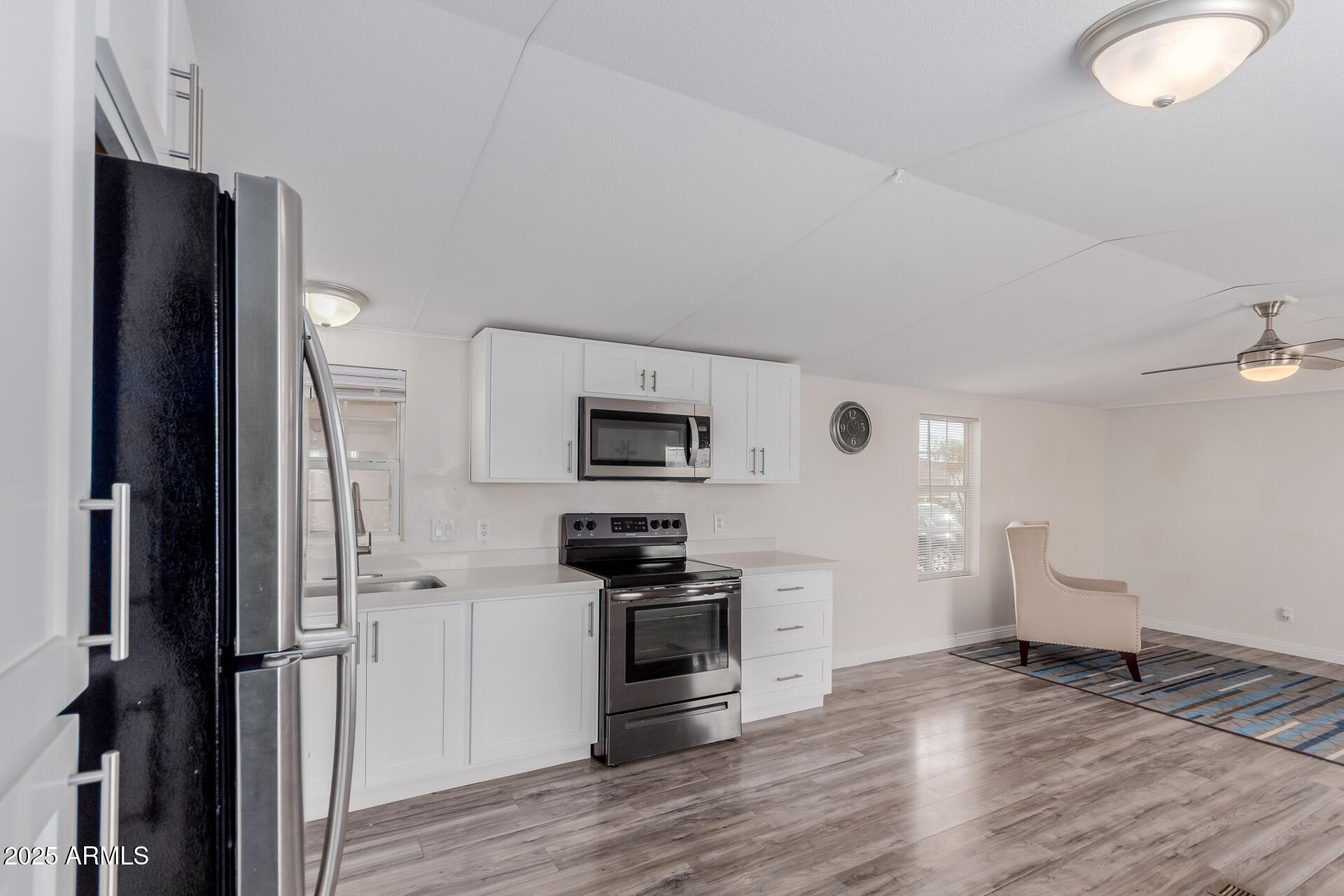 2000 South Apache Road, Unit 276 Buckeye, AZ 85326 - Photo 9 of 27 a kitchen with a refrigerator and a stove top oven