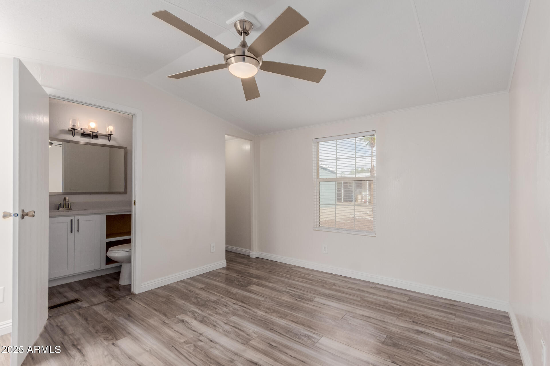 2000 South Apache Road, Unit 276 Buckeye, AZ 85326 - Photo 10 of 27 wooden floor in an empty room with a window