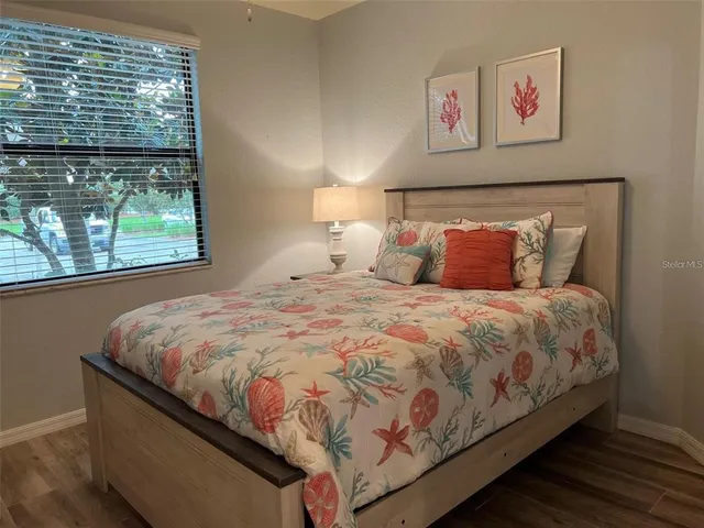 a bed sitting in a bedroom next to a window