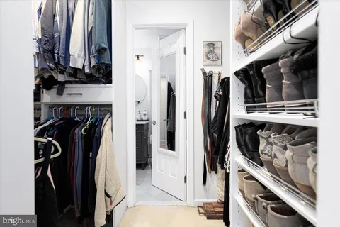 a bathroom with a sink a toilet a mirror and shower