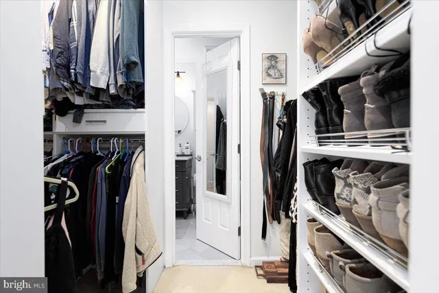 a bathroom with a sink a toilet a mirror and shower