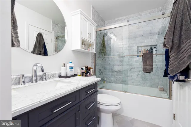 a living room with furniture a bookshelf and a wooden floor