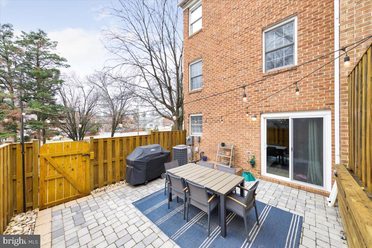 2049 South Glebe Road Arlington, VA 22206 - Photo 20 of 25 a view of a patio with table and chairs and wooden floor