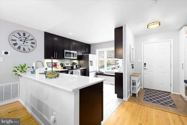 a kitchen with a sink a stove and refrigerator