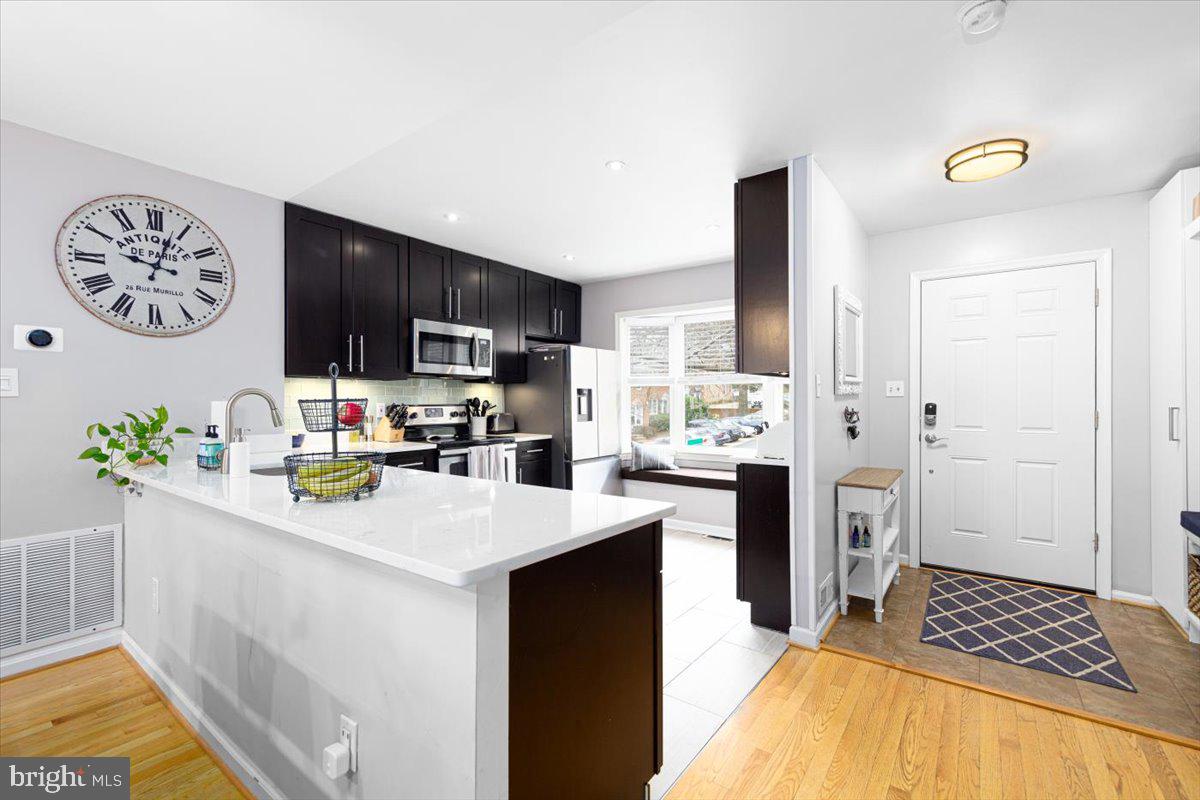 2049 South Glebe Road Arlington, VA 22206 - Photo 4 of 25 a kitchen with a refrigerator and a stove top oven