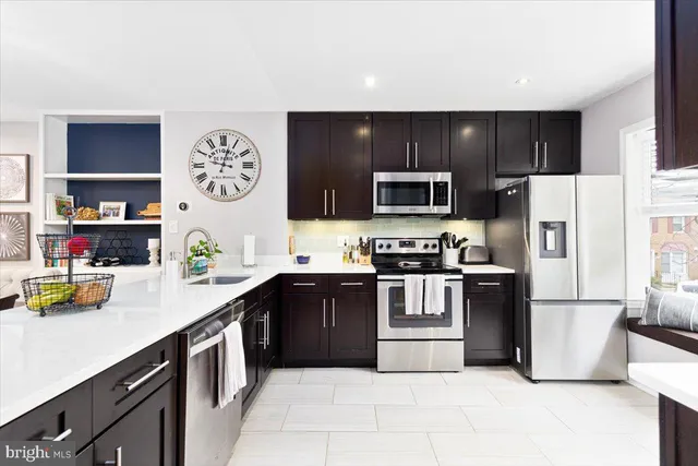a kitchen with stainless steel appliances granite countertop a stove and cabinets