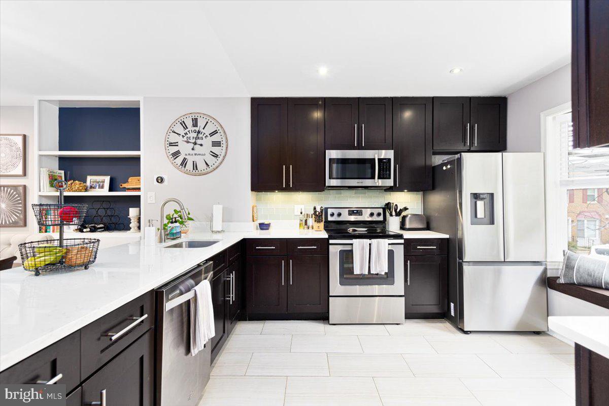 2049 South Glebe Road Arlington, VA 22206 - Photo 5 of 25 a kitchen with a sink a stove and refrigerator