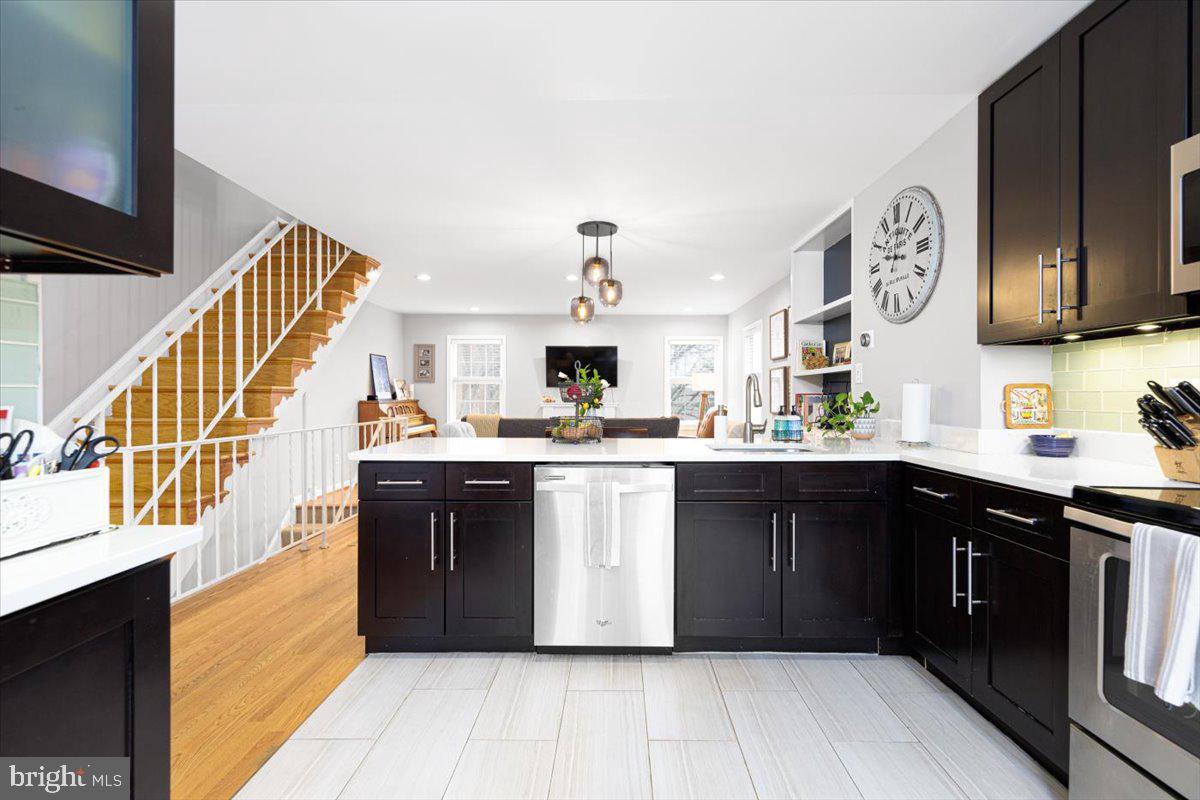 2049 South Glebe Road Arlington, VA 22206 - Photo 6 of 25 a kitchen with stainless steel appliances granite countertop a stove and cabinets