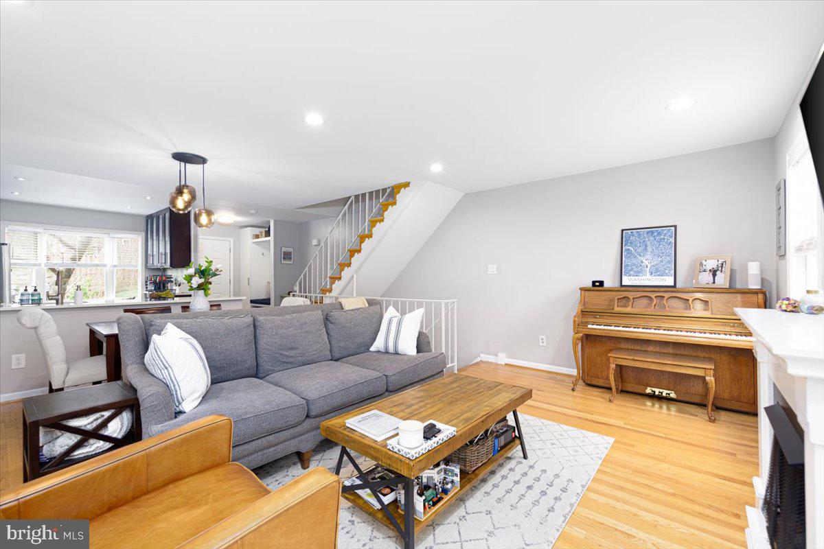 2049 South Glebe Road Arlington, VA 22206 - Photo 8 of 25 a living room with furniture and a dining table with wooden floor