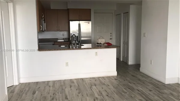a view of a kitchen with wooden floor