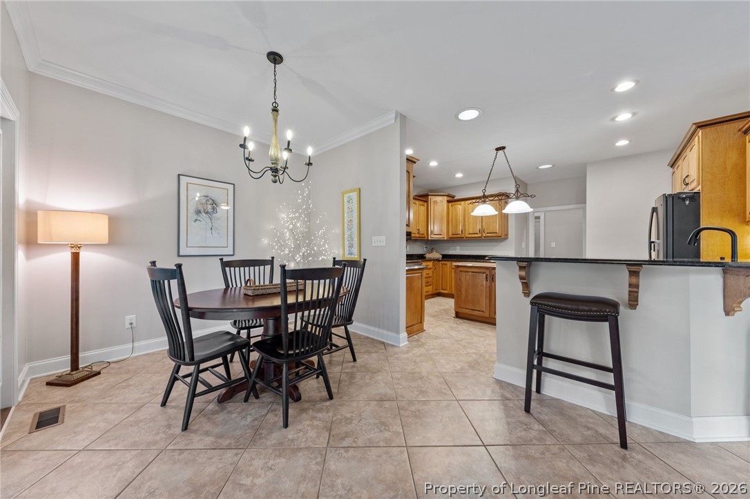 30180 East Lake Road Wagram, NC 28396 - Photo 19 of 42 a view of a dining room with furniture and a chandelier