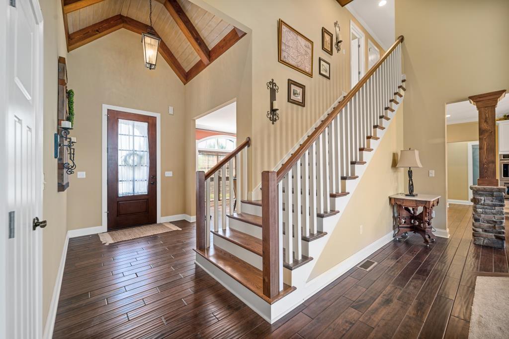 a view of an entryway with wooden floor and stairs