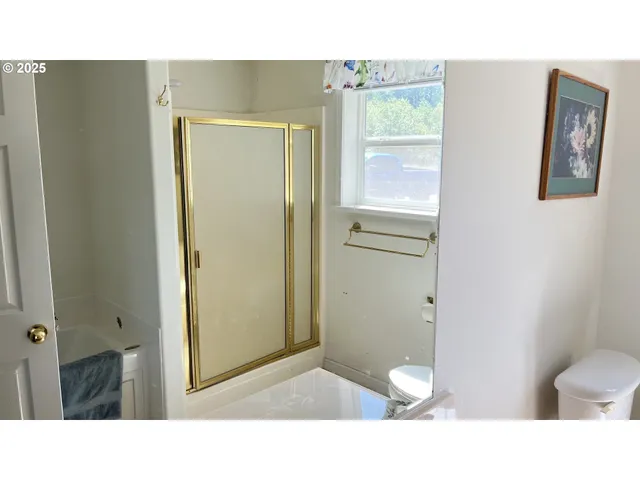 a living room with a bed furniture and a window
