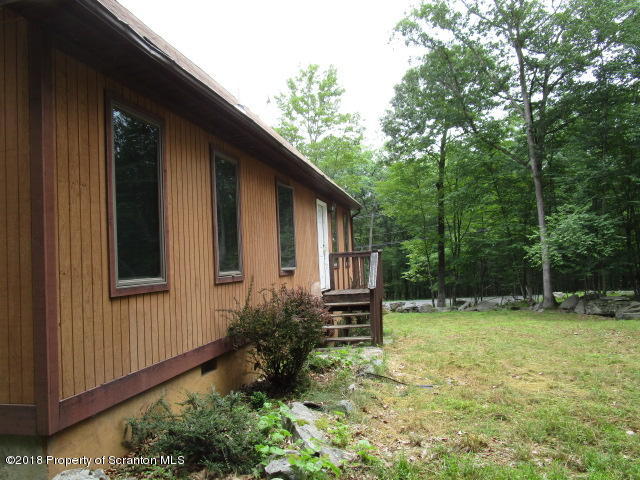 5687 Decker Road Bushkill, PA 18324 - Photo 8 of 8 a backyard of a house with yard and trampoline