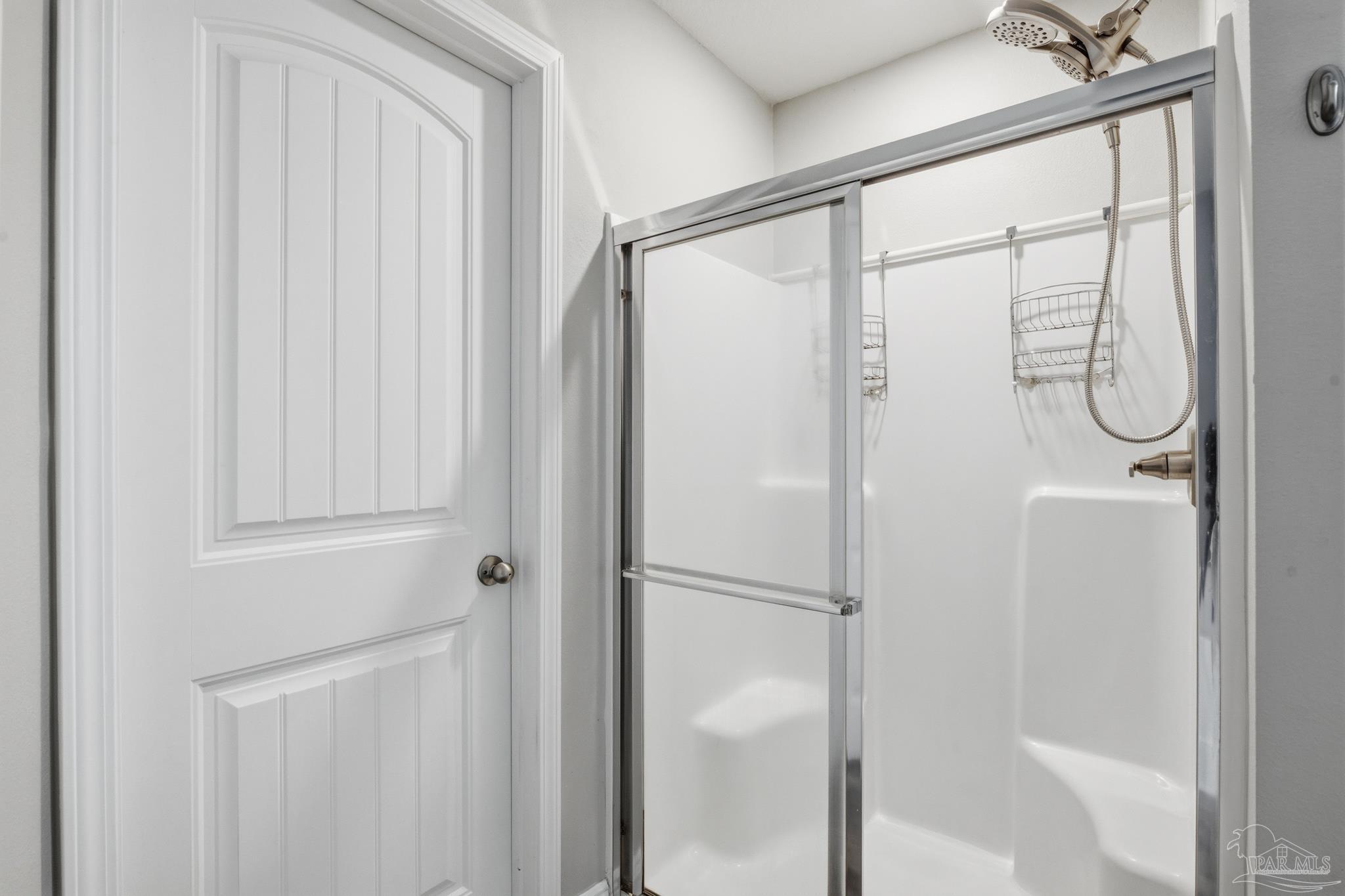 5661 Cane Syrup Circle Pace, FL 32571 - Photo 11 of 20 a bathroom with a glass shower door