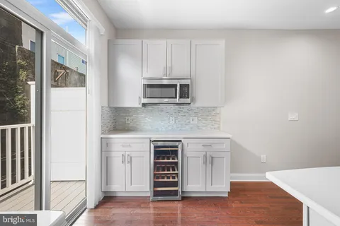 a kitchen with stainless steel appliances granite countertop a stove and a microwave