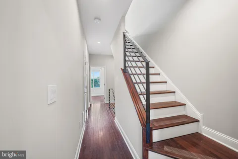 a view of entryway and gallery with wooden floor