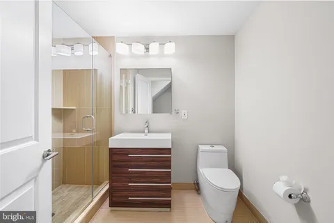a bathroom with a toilet a sink and mirror