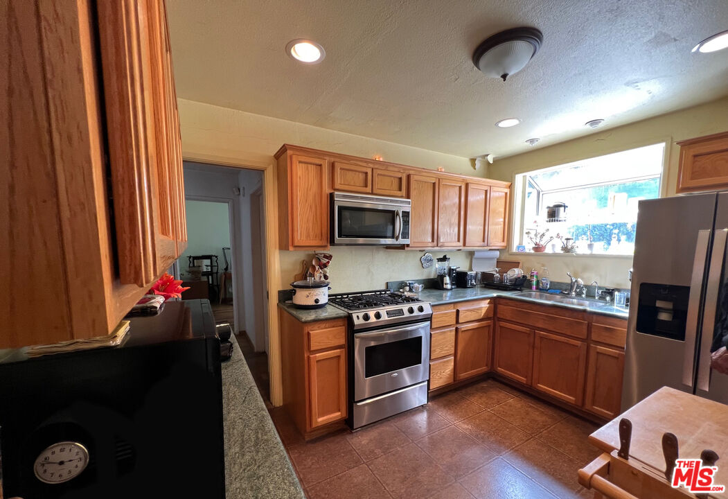 5280 Sanchez Drive Los Angeles, CA 90008 - Photo 11 of 30 a kitchen with sink refrigerator and microwave
