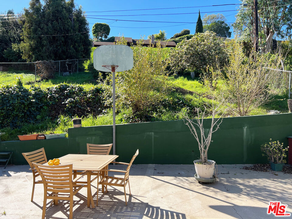 5280 Sanchez Drive Los Angeles, CA 90008 - Photo 18 of 30 a view of a patio with table and chairs potted plants and large tree