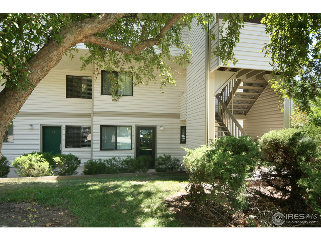 1705 Heatheridge Road, Unit L105 Fort Collins, CO 80526 - Photo 1 of 9 a view of a house with a garden