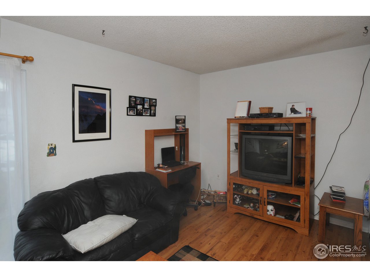 1705 Heatheridge Road, Unit L105 Fort Collins, CO 80526 - Photo 3 of 9 a living room with furniture and a flat screen tv