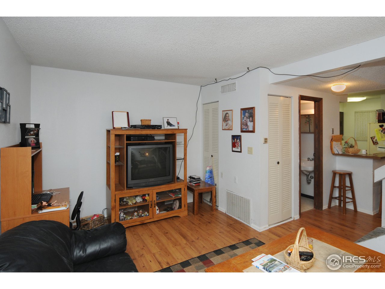 1705 Heatheridge Road, Unit L105 Fort Collins, CO 80526 - Photo 4 of 9 a living room with furniture and a flat screen tv