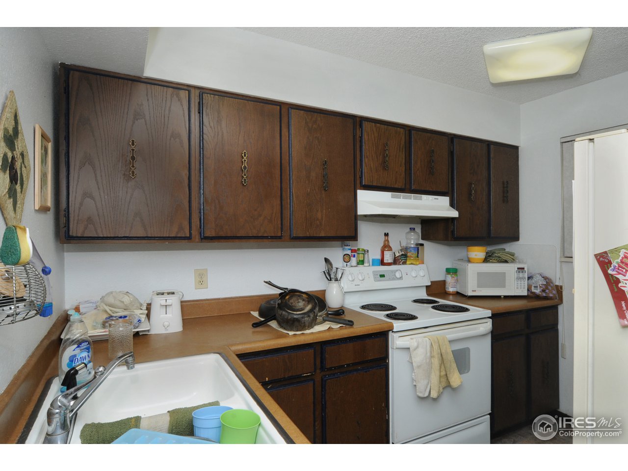 1705 Heatheridge Road, Unit L105 Fort Collins, CO 80526 - Photo 6 of 9 a kitchen with a sink cabinets and black appliances