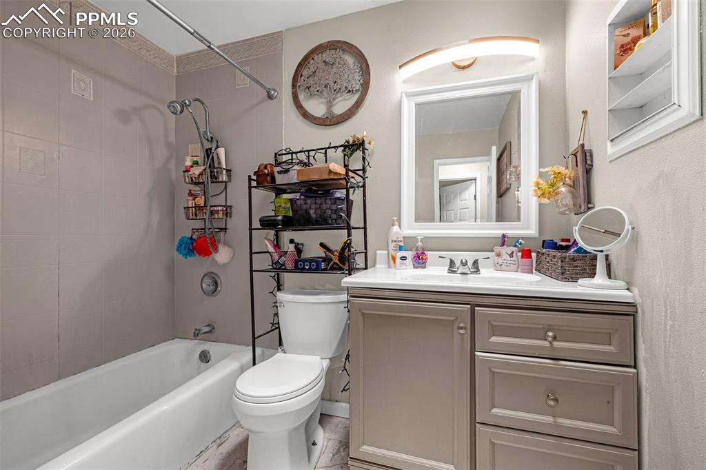 7045 Roaring Spring Terrace Fountain, CO 80817 - Photo 12 of 45 a bathroom with a sink a toilet and a mirror