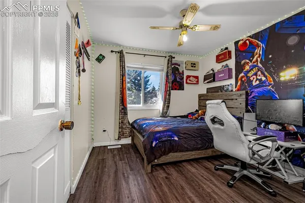 a bedroom with a bed and a chandelier