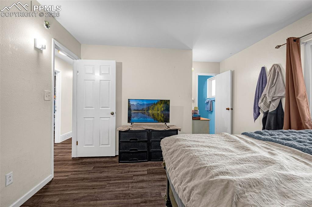 7045 Roaring Spring Terrace Fountain, CO 80817 - Photo 15 of 45 a spacious bedroom with a bed and a flat screen tv