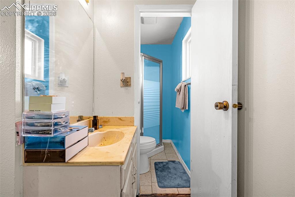 7045 Roaring Spring Terrace Fountain, CO 80817 - Photo 16 of 45 a bathroom with a sink and mirror with bathtub