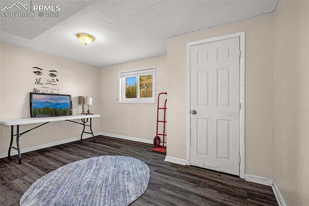 7045 Roaring Spring Terrace Fountain, CO 80817 - Photo 25 of 45 a living room with furniture and a flat screen tv