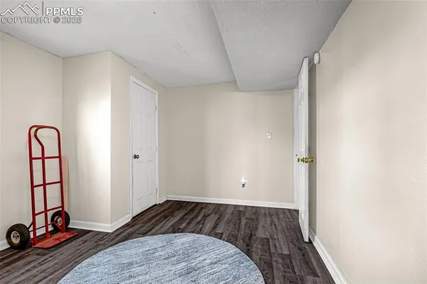 a view of bedroom with a bed and wooden floor
