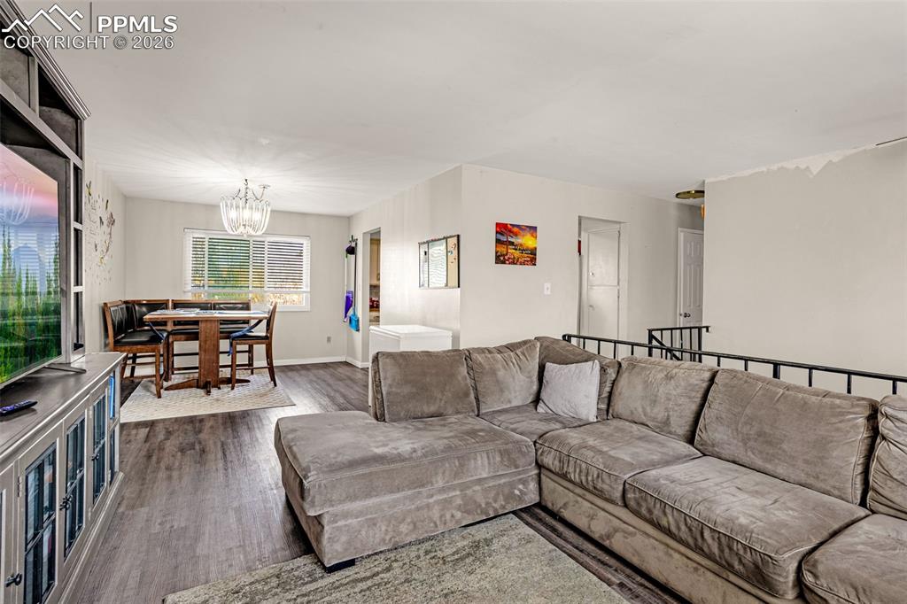 7045 Roaring Spring Terrace Fountain, CO 80817 - Photo 4 of 45 a living room with furniture and wooden floor