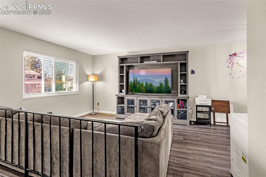 7045 Roaring Spring Terrace Fountain, CO 80817 - Photo 6 of 45 a living room with furniture and a flat screen tv