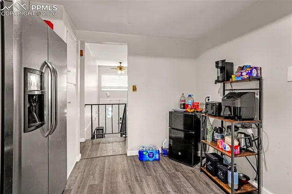 a very nice looking room with wooden floor and a closet