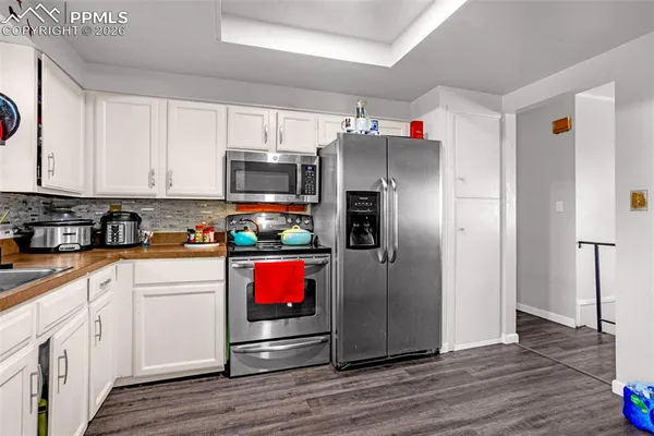 a kitchen with stainless steel appliances a refrigerator sink and cabinets